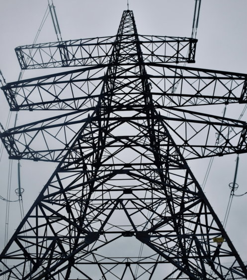 a-tall-metal-tower-with-lots-of-wires-above-it.jpg A tall metal tower with lots of wires above it